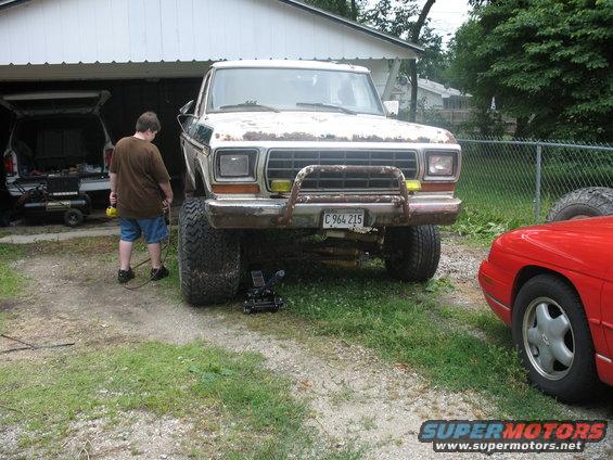 Front view of a lifted 1979 Ford F-Series pickup truck with a rusty bull bar and license plate C 964 215
