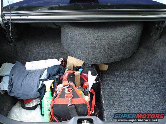 Trunk interior with tools, spare tire, and cleaning supplies