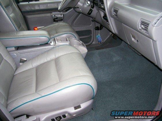 Gray leather seats with teal piping, center console, and dashboard of a 1994 Ford Explorer