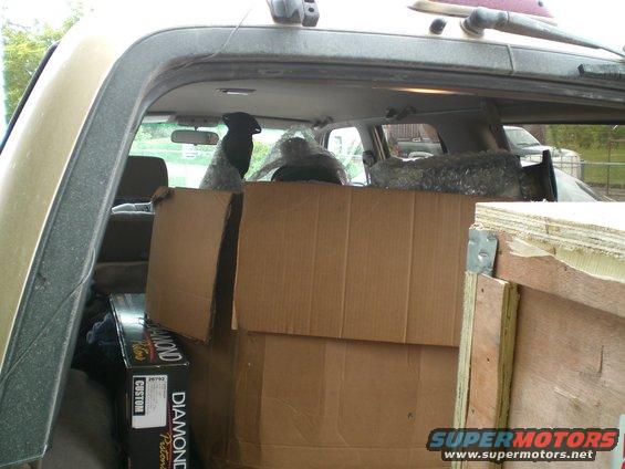view inside cargo area of SUV, boxes and bubble wrap piled up