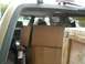 1995 Ford Probe - The rear cargo area of an SUV is filled with boxes and other items, obscuring the view of the interior.
