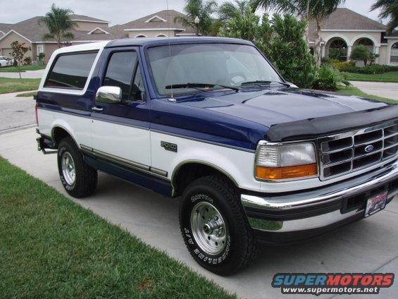 Blue and white Ford Bronco parked on a driveway