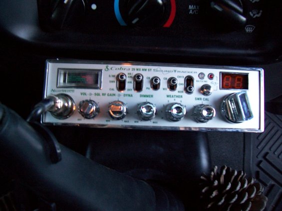 CB radio mounted on dashboard, showing knobs and digital display