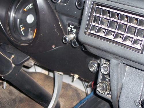 Dashboard view with fuel gauge, air vents, and various switches