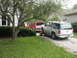 1993 Ford Explorer - A white 1995 Ford Explorer is being towed by a red truck on a gravel driveway.