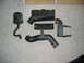 1996 Dodge 2500 - Several black plastic air intake components, including a resonator, bellows, and intake tubes, are arranged on a carpeted surface.