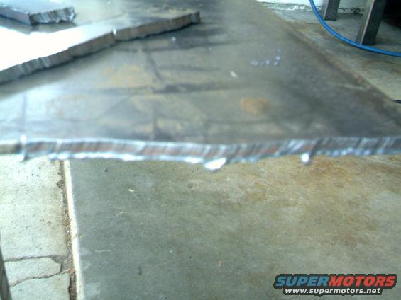 Cut metal pieces on a workbench surface