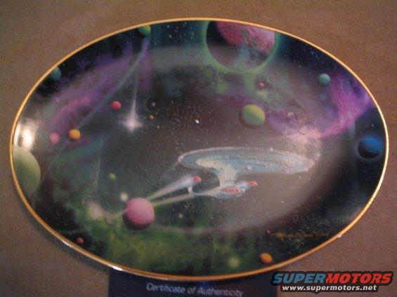 Plate with Starship Enterprise flying through space with planets and nebulae