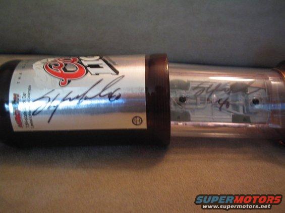 Signed Coors Light beer can inside a clear display tube with brown end caps