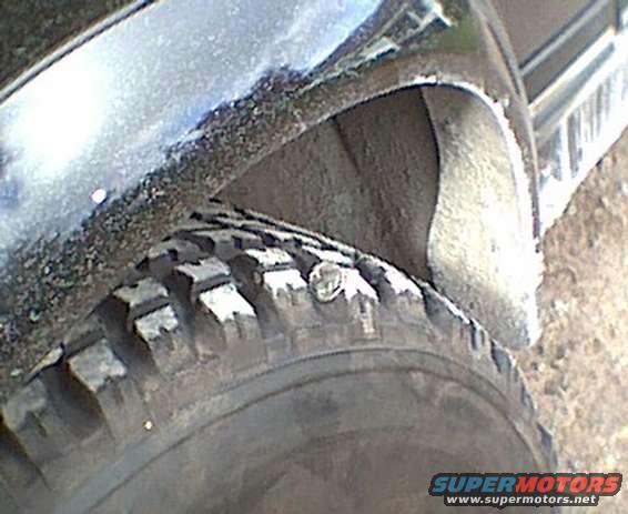 Close-up of a tire and wheel well area of a vehicle