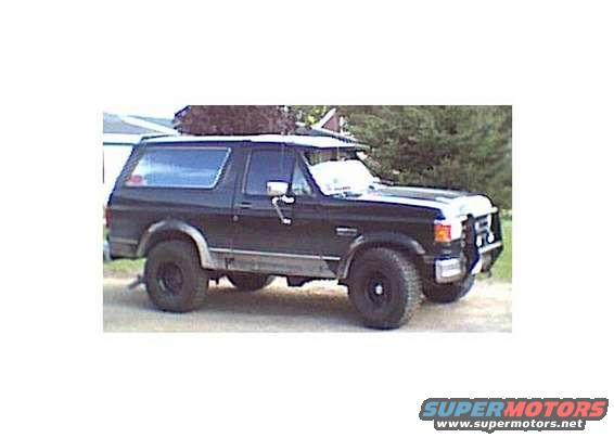 Black 1987 Ford Bronco SUV, 3/4 front view, with aftermarket bull bar and roof rack