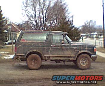 Side view of a 1987 Ford Bronco in a muddy setting