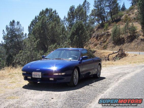 Blue 1995 Ford Probe parked on gravel road