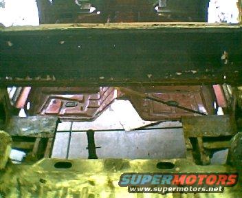 rusted floor pan of a car, viewed from above