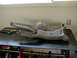 1996 Ford Bronco - Two suspension control arms and a differential housing are shown on a workbench, likely for a vehicle's front suspension system.