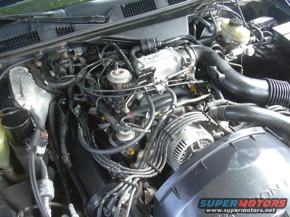 Engine bay with visible alternator and intake manifold