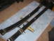 1991 Ford Bronco - Two black leaf springs, possibly for a vehicle modification, are laid out on a blue cloth with tools nearby. One spring has a brass tag wit…