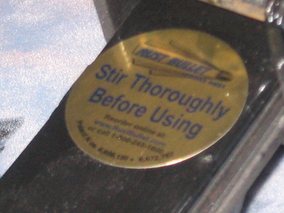 Rust Bullet label with instructions to stir thoroughly before using, and website/phone number for reordering