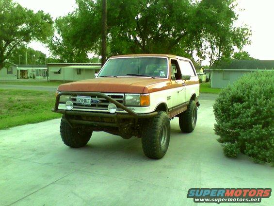 Ford Bronco with aftermarket bumper and lift kit parked on a driveway