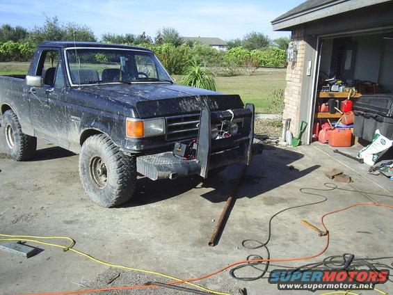Black 1982 Ford Bronco with brush guard parked in driveway
