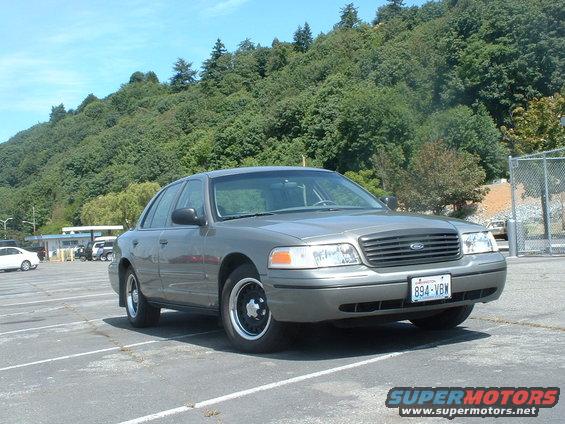 Gray 2000 Ford Crown Victoria sedan parked in a lot