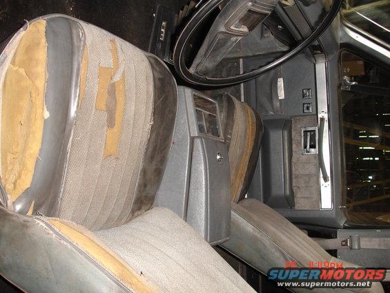 Interior shot of a truck's worn seats and dashboard