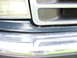 1994 Ford Bronco - Close-up of the front grille and headlight assembly on a 1994 Ford Bronco.