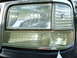 1994 Ford Bronco - Detail of a vehicle's front lighting assembly, including the headlight and turn signal.