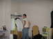 1988 Ford Bronco - A man stands in a room with clothes hanging on a rack, a toy microwave, and stuffed animals.