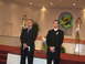 1988 Ford Bronco - Two men in formal attire stand on a raised platform in a church setting, awaiting an event.