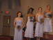 1988 Ford Bronco - Bridesmaids stand on a stage holding flowers, with an exit sign visible in the background.