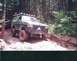 1989 Ford Bronco - This modified SUV navigates a challenging off-road course, with another vehicle visible in the background.