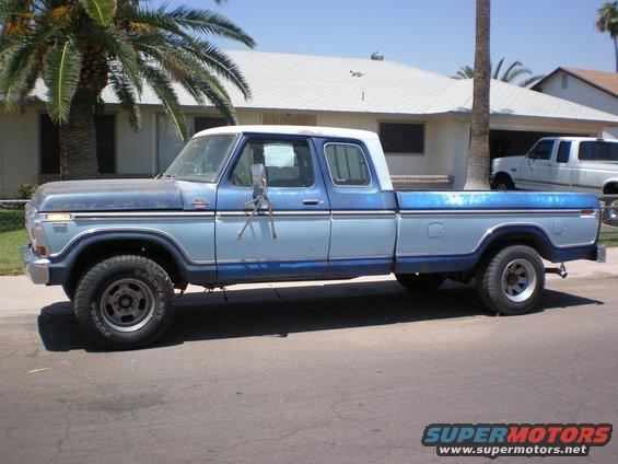 Side view of a blue 1979 Ford F-150/F-250 crew cab pickup truck parked on a street