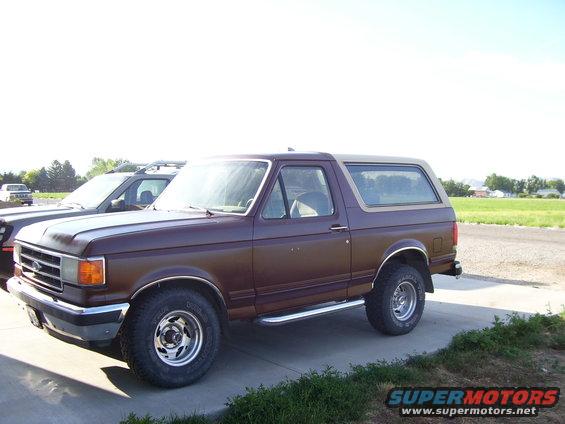Brown 1990 Ford Bronco parked next to another SUV