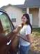 1990 Ford Bronco - A woman poses next to a brown SUV in front of a house.