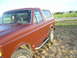 1990 Ford Bronco - This 1990 Ford Bronco is shown from the front three-quarter angle, highlighting its classic SUV body style.