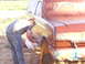 1990 Ford Bronco - Painting the fender of a 1990 Ford Bronco with a spray gun.