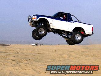 1996 Ford Bronco prerunner mid-air jump over sand dunes