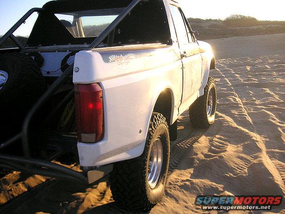 1996 Ford Bronco prerunner with roll cage on sand dunes