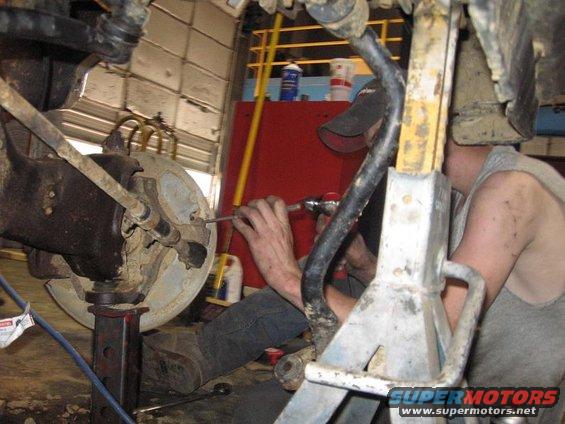 my friend workin on it..my snap-on tool box in the back ground, and a bottle of DOT 3 brake fluid