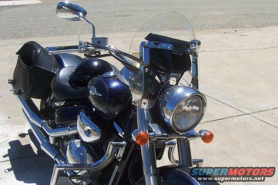 Front view of a dark blue motorcycle with saddlebags and a windshield