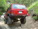 1996 Jeep Cherokee - 1996 Jeep Cherokee navigating a difficult rocky trail with large tires.