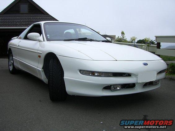 White 1995 Ford Probe parked in front of a house