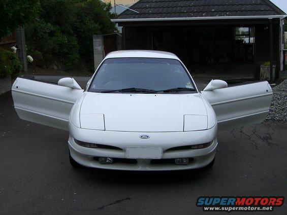 White Ford Probe with doors open, front view. The car appears to be in good condition