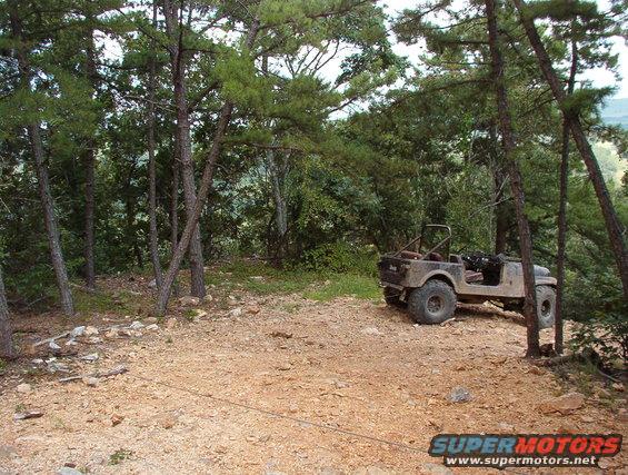 20heep.jpg Trash on the trail!  Our entrance to the Rubicon was blocked by this abandoned Heep, whose LHF steering knuckle was no longer attached to the axle housing.  We did him the favor of pulling it back up to level ground.  Unfortunately, his LHR tire came off the rim in the process, and the LHF tie rod end separated.  Sorry, but I doubt he could have gotten it out of there in any better condition.