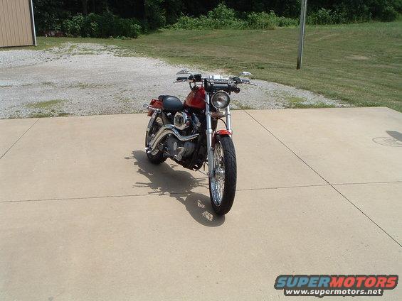 Red 2002 Harley-Davidson Sportster Custom motorcycle parked on concrete