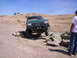 1989 Ford Bronco - A green 1987 Ford F-Series truck is shown navigating a rocky trail, demonstrating its off-road capabilities.