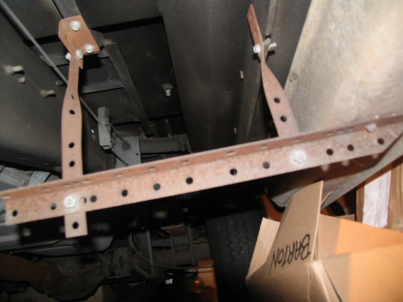 Running board mounting brackets on underside of vehicle. Text on box reads 'BARTON'