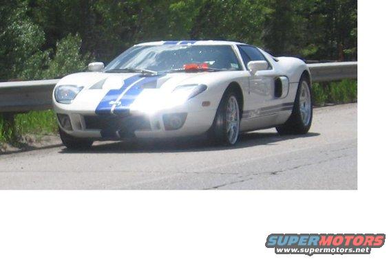 White and blue striped 2005 Ford GT parked on a road