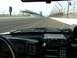 1993 Ford Mustang - View from inside a vehicle at the Indianapolis Motor Speedway, showing the track and grandstands.